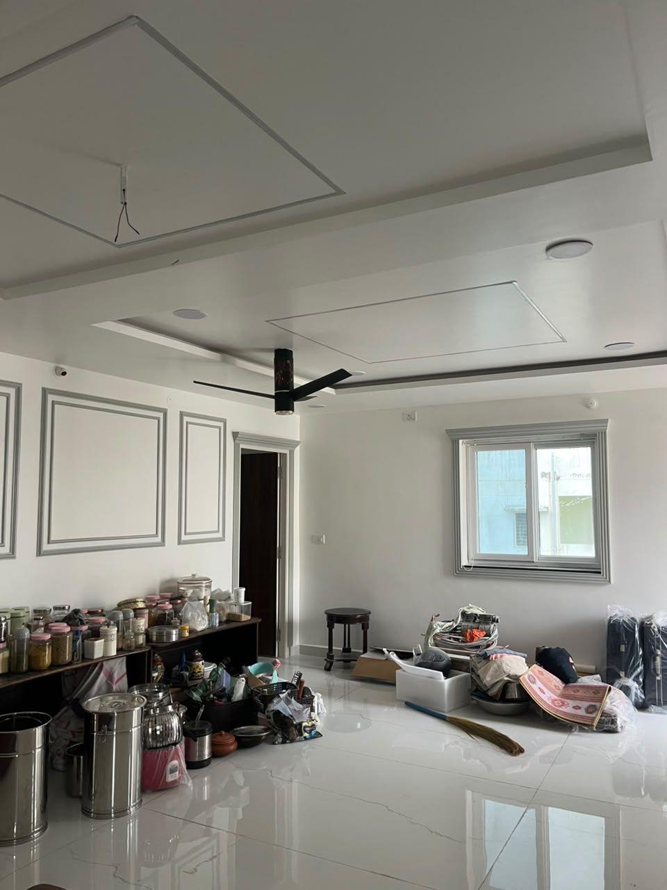 Living area interior with false ceiling and wall paneling by RA Contractor, Hyderabad